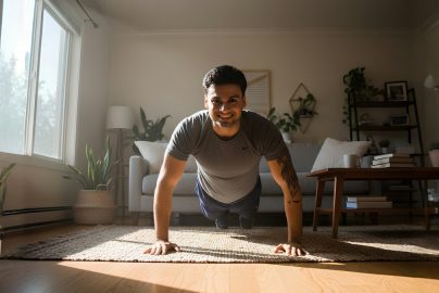 Man doing push-ups in a sunlit living room
