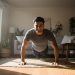 Man doing push-ups in a sunlit living room
